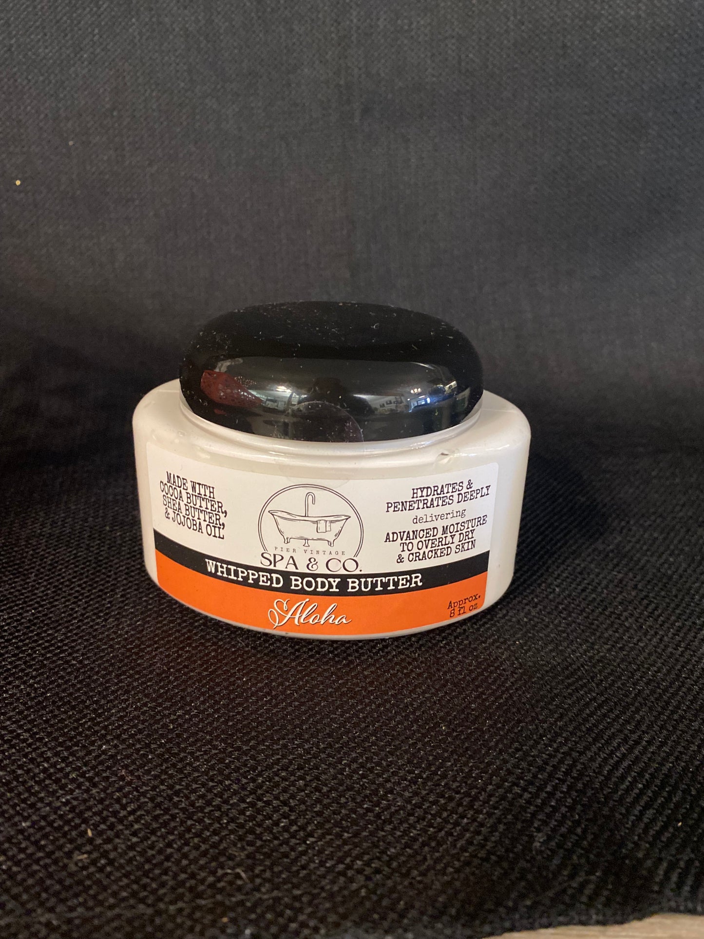 Container of Whipped Body Butter called Aloha by Pier Vintage Spa & Co. on a dark textured surface
