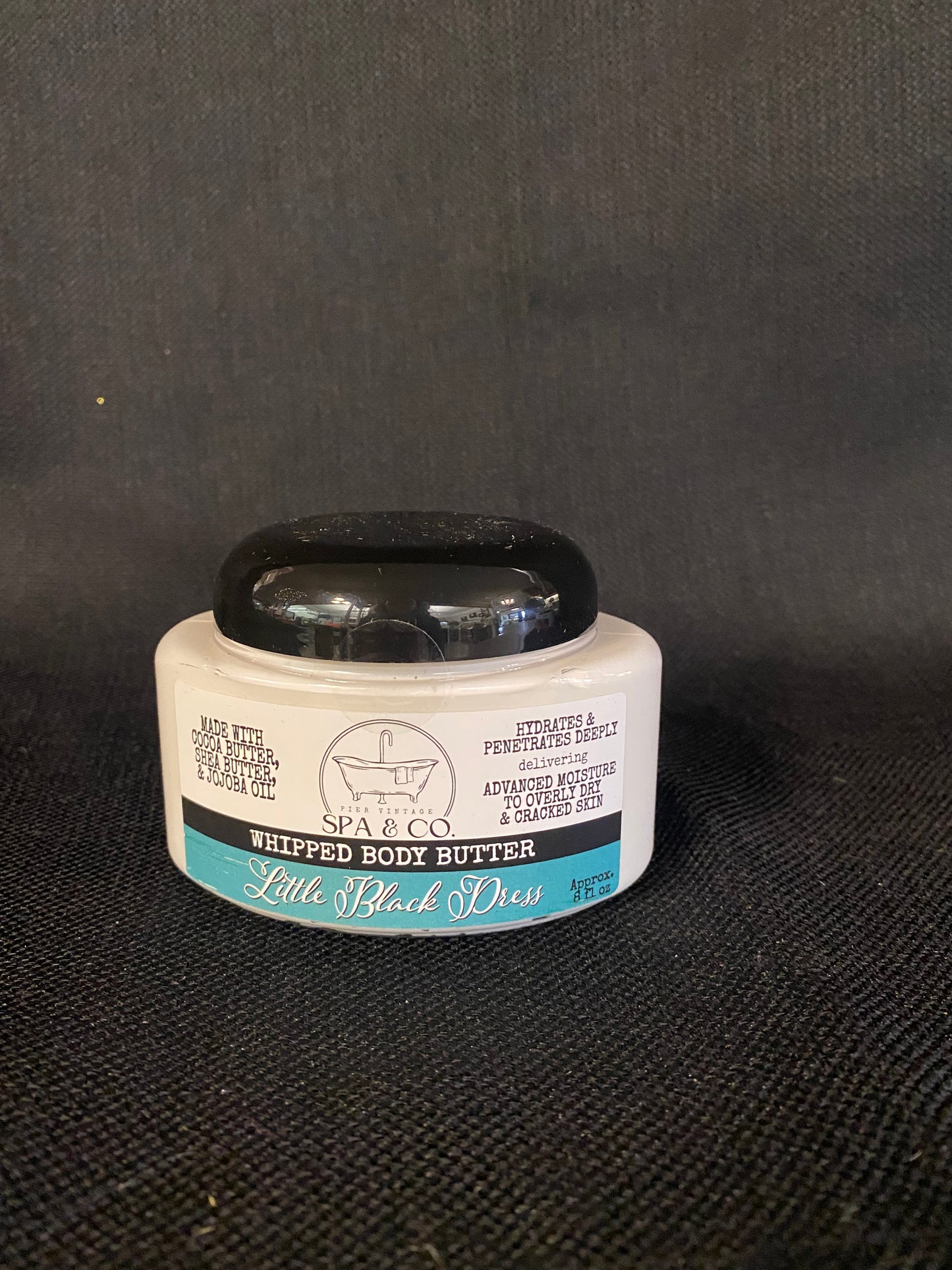 Container of Whipped Body Butter called Little Black Dress by Pier Vintage Spa & Co. on a dark textured surface