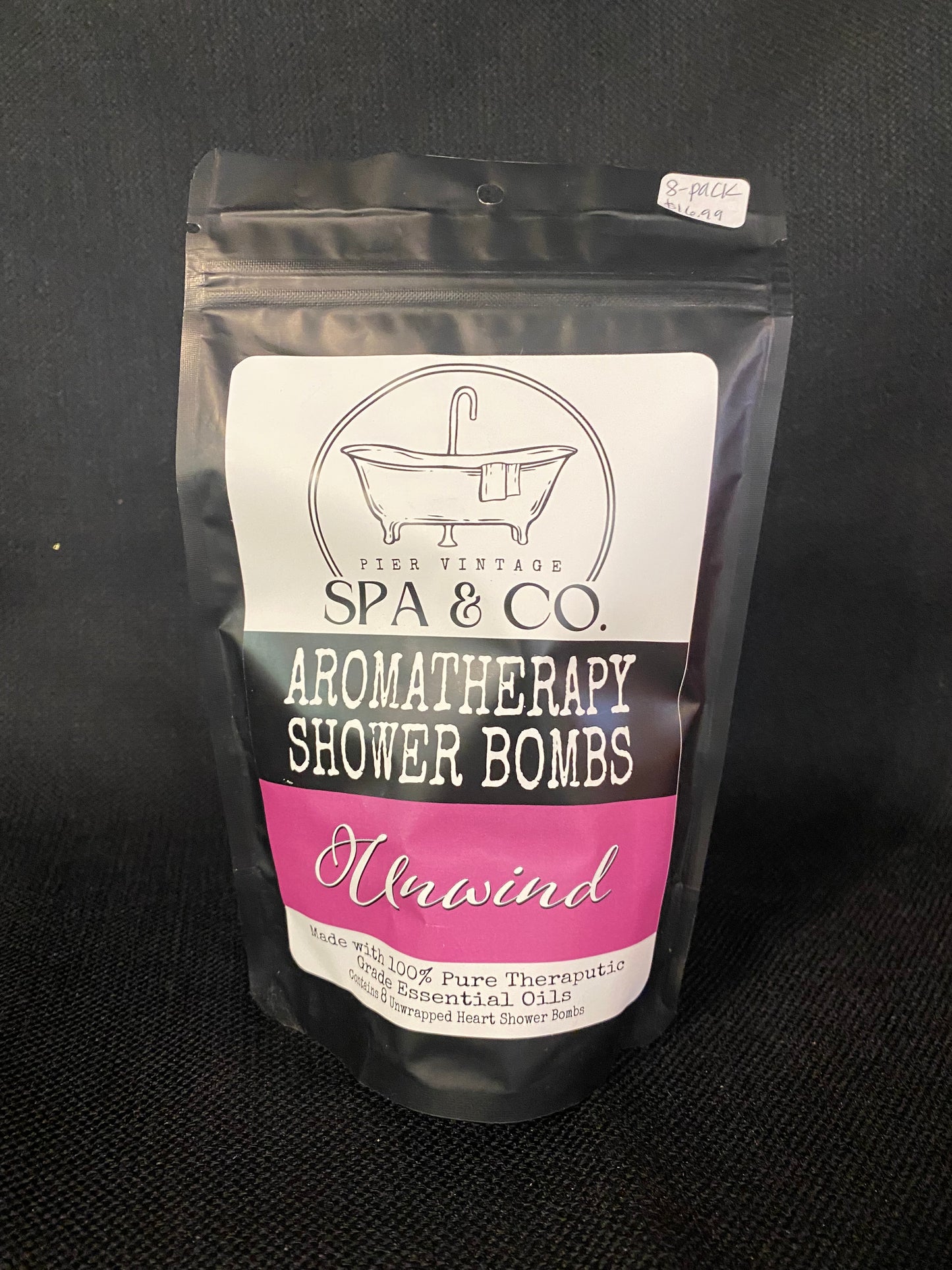 Packaged aromatherapy shower bomb with Pier Vintage Spa & Co branding on a dark background