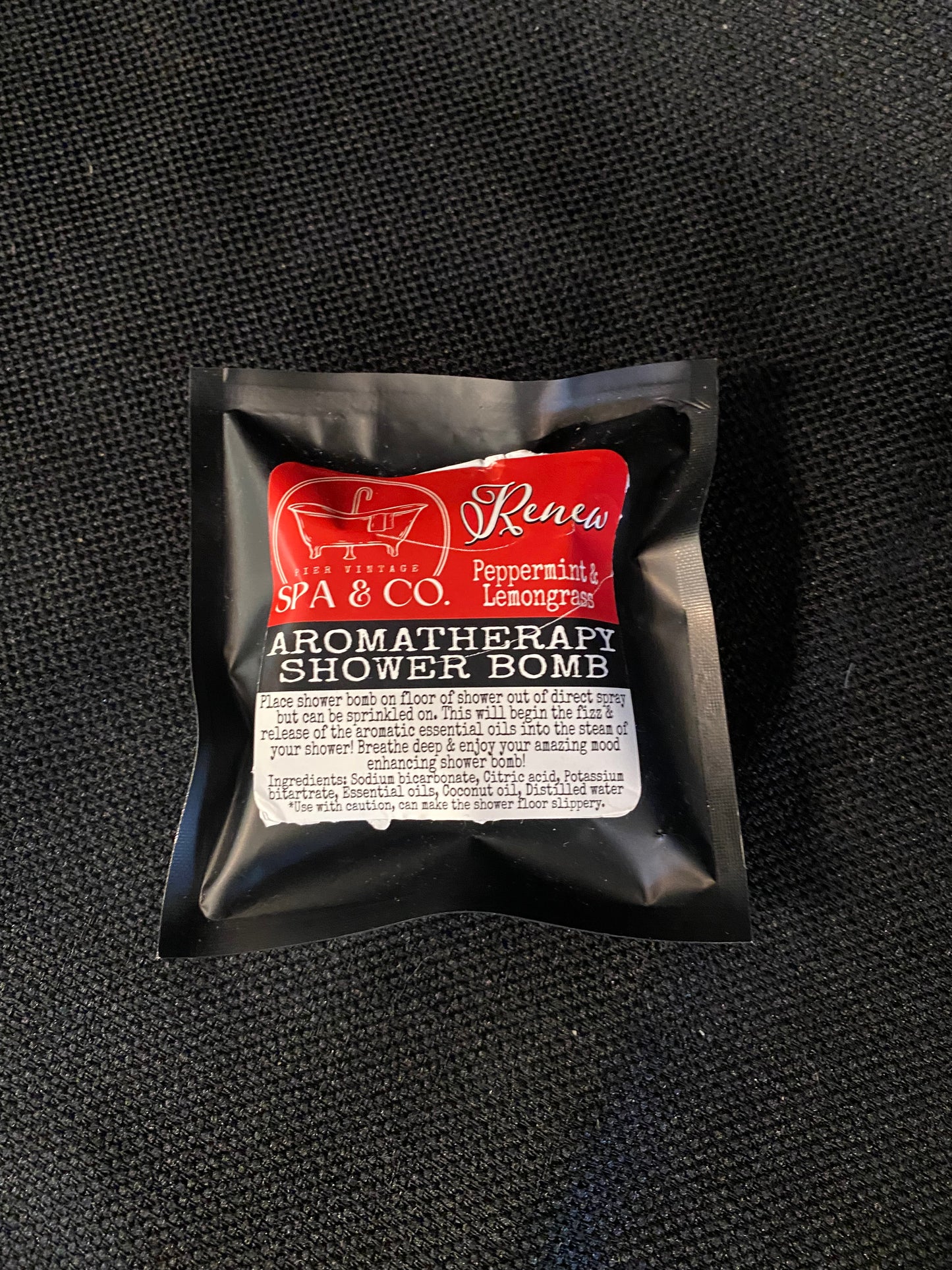 Aromatherapy shower bomb packaging on a black background