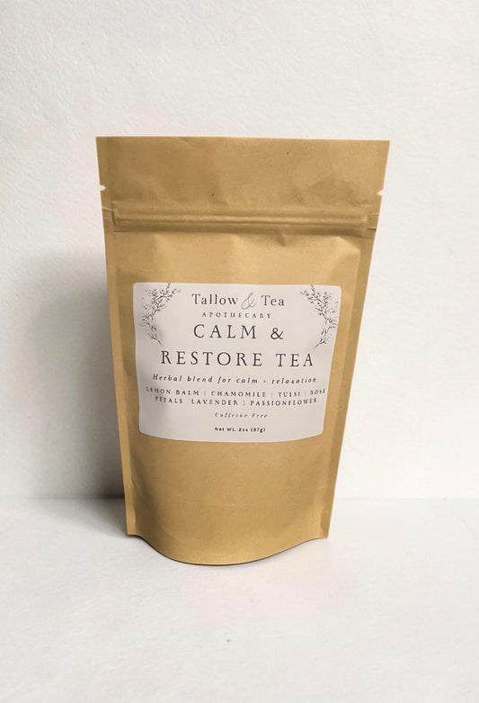 Kraft paper tea bag labeled 'Calm & Restore Tea' on a white background