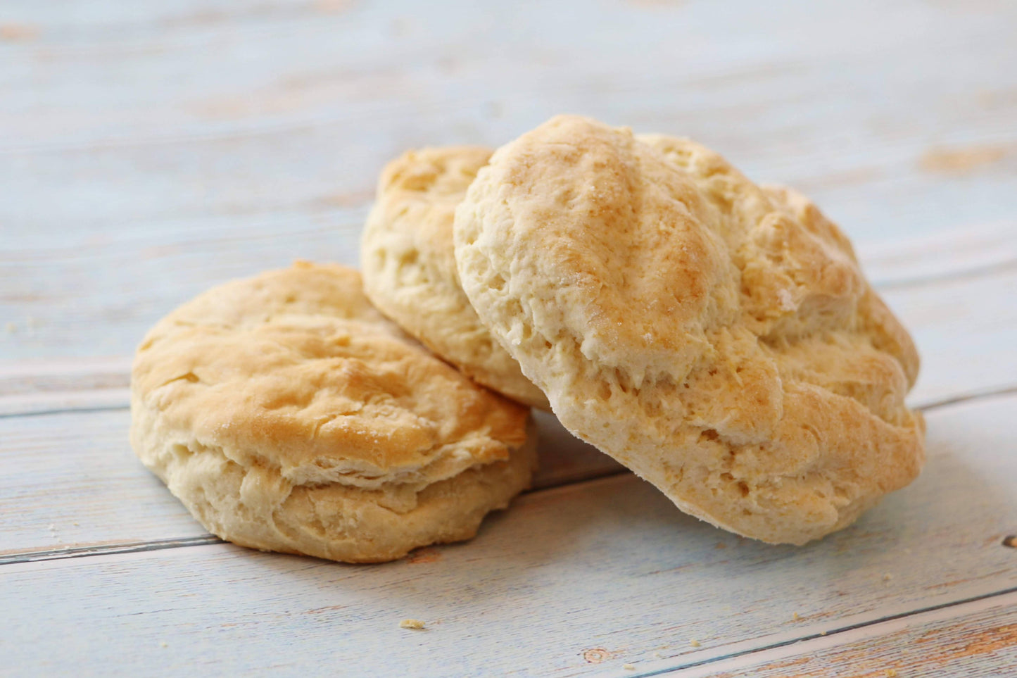 Three biscuits on a light wooden surface