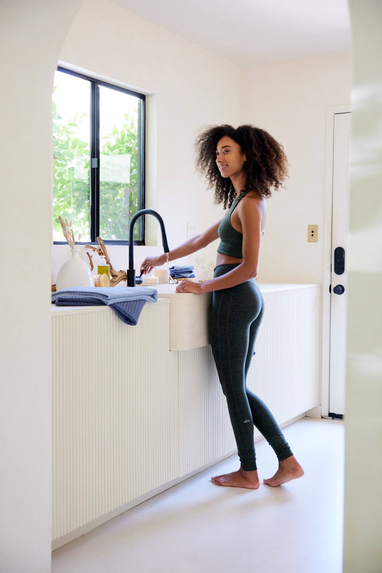 Woman washing dishes in a modern kitchen