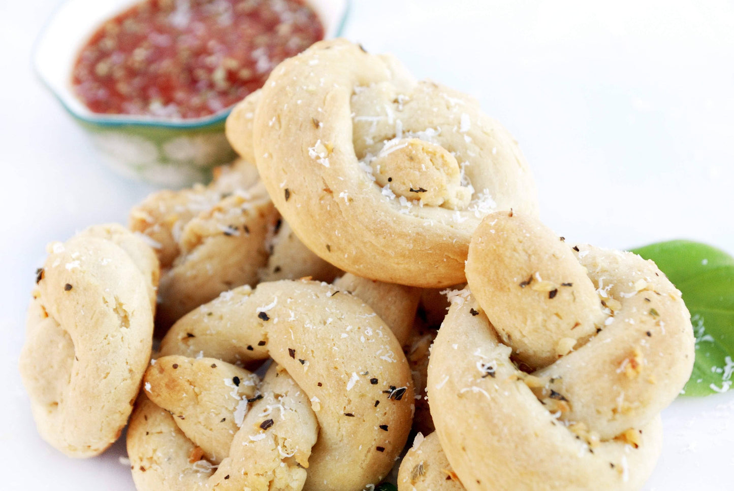 Baked goods with herbs and cheese on a white plate