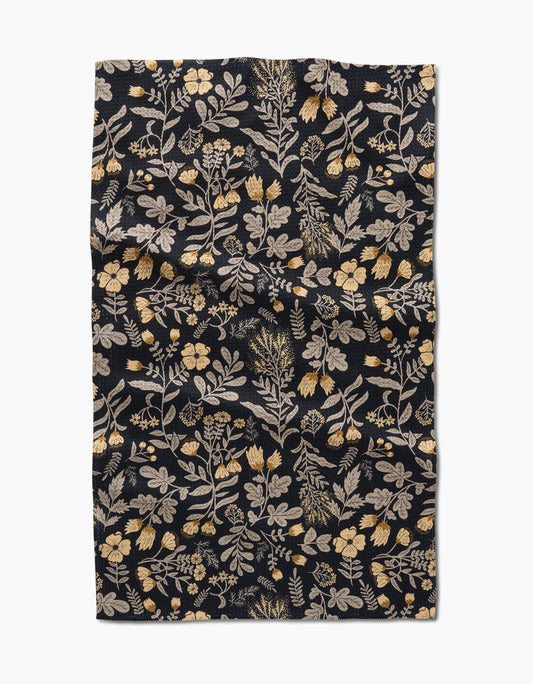 Geometry kitchen tea towel with floral patterned fabric on a black background