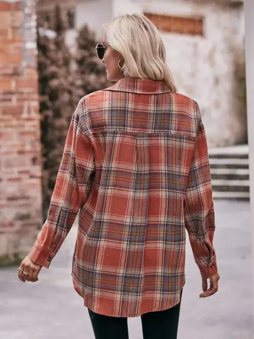 Woman wearing a plaid shirt with a blurred background