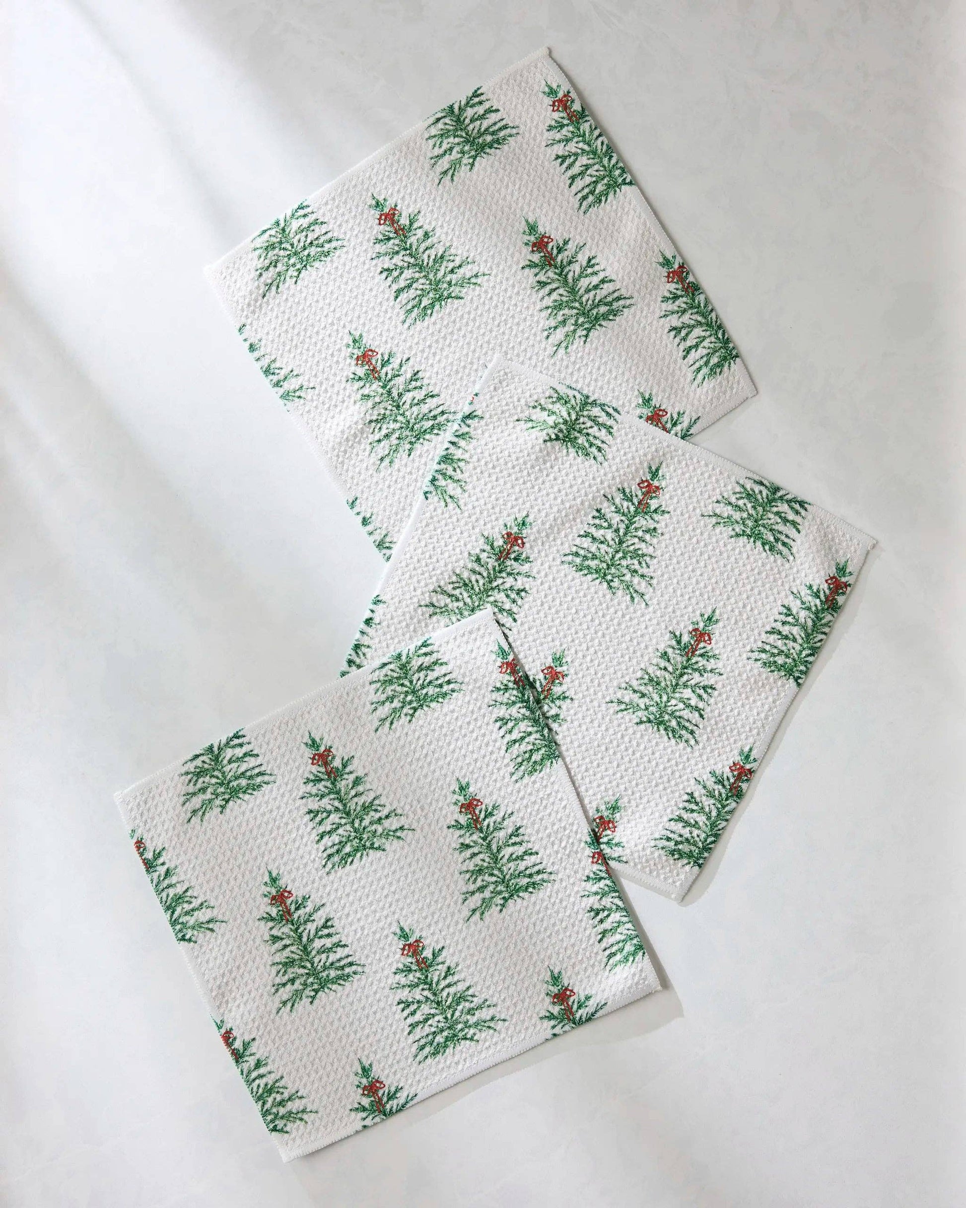 Geometry Dish cloth Set of three white towels with green leaf pattern on a light gray background