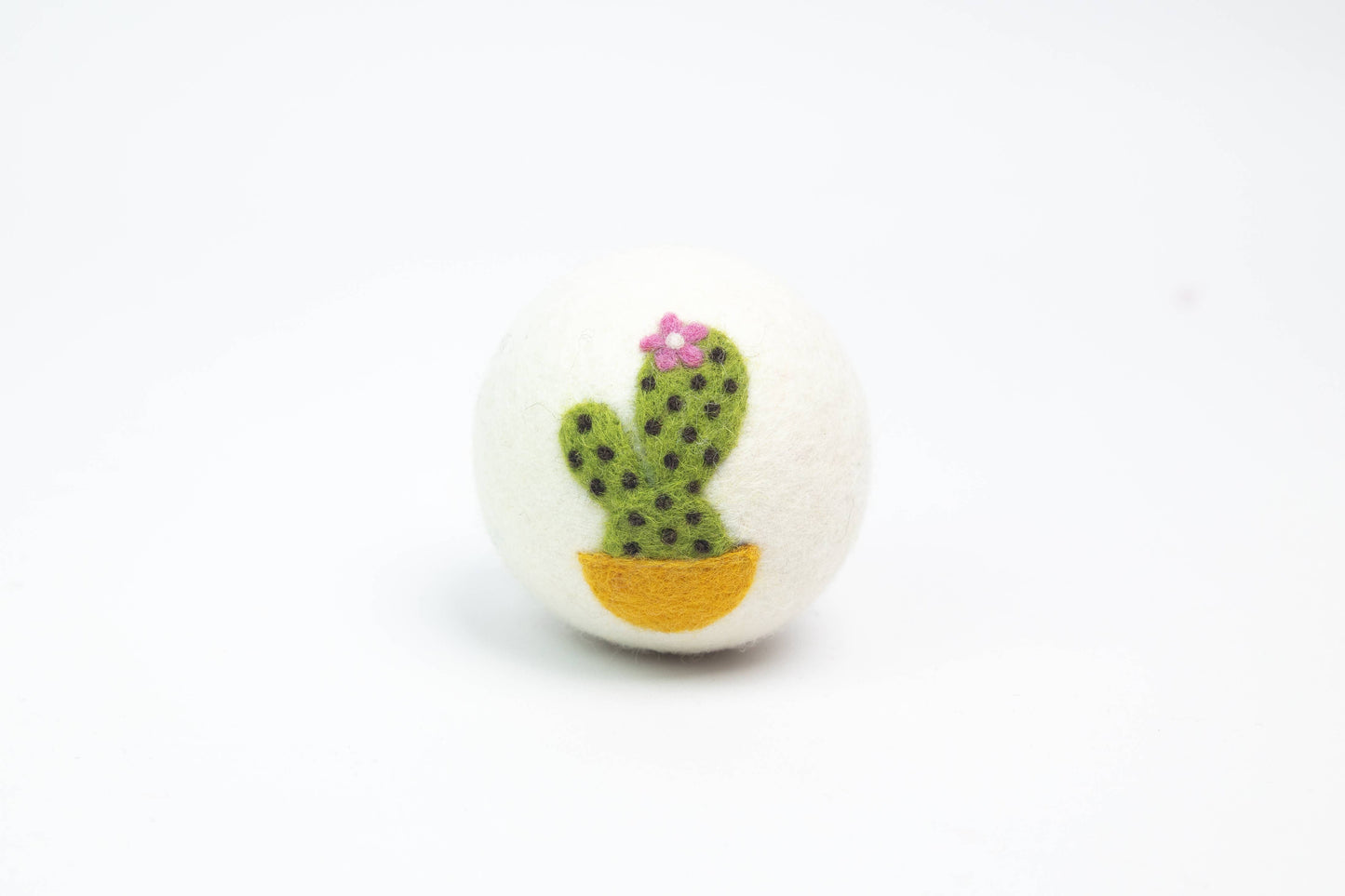 white wool dryer ball with a cactus design on a white background