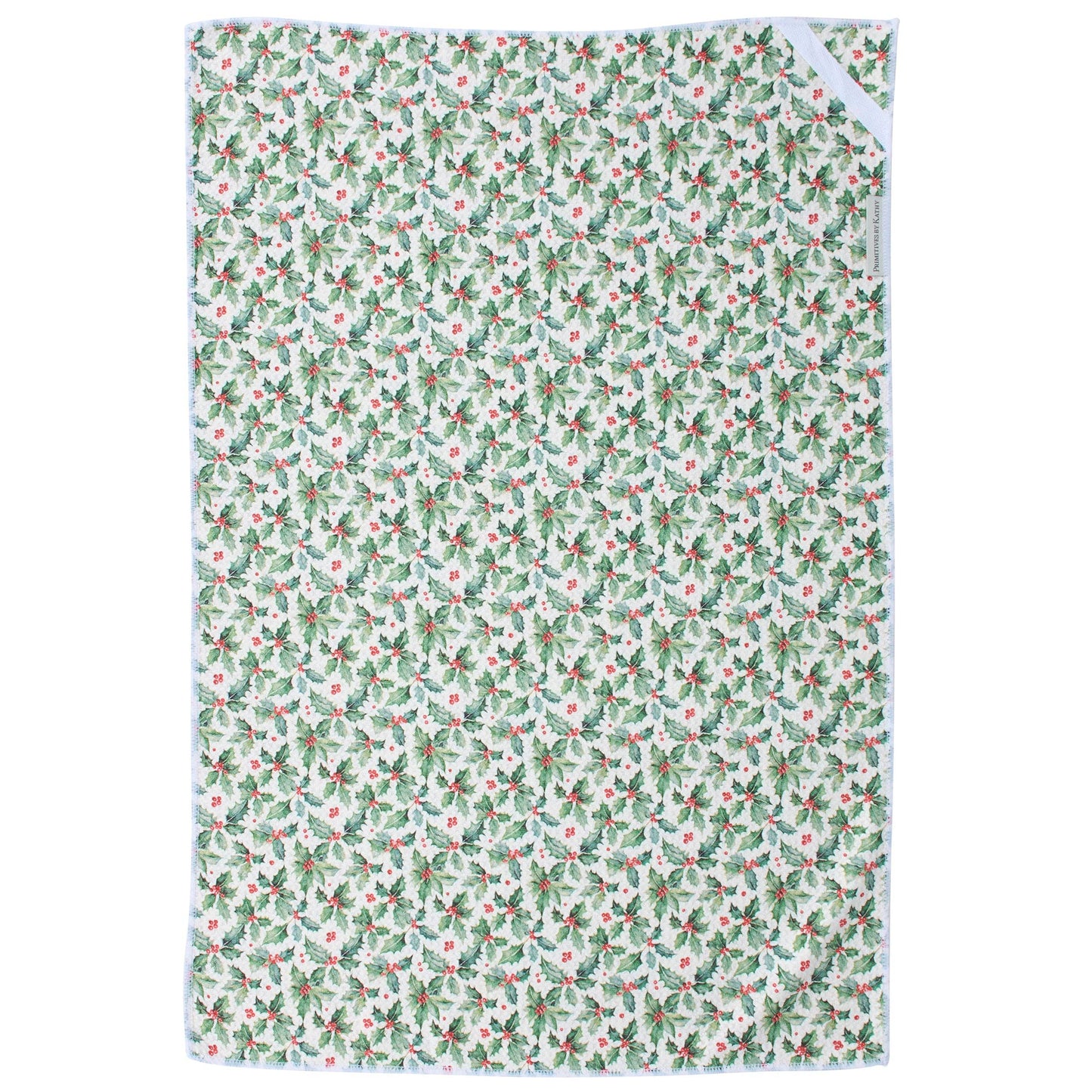 A rectangular kitchen towel with a repeating holly and berry pattern in green, and red on a white background, featuring a white border and a white ribbon tie at the top right.