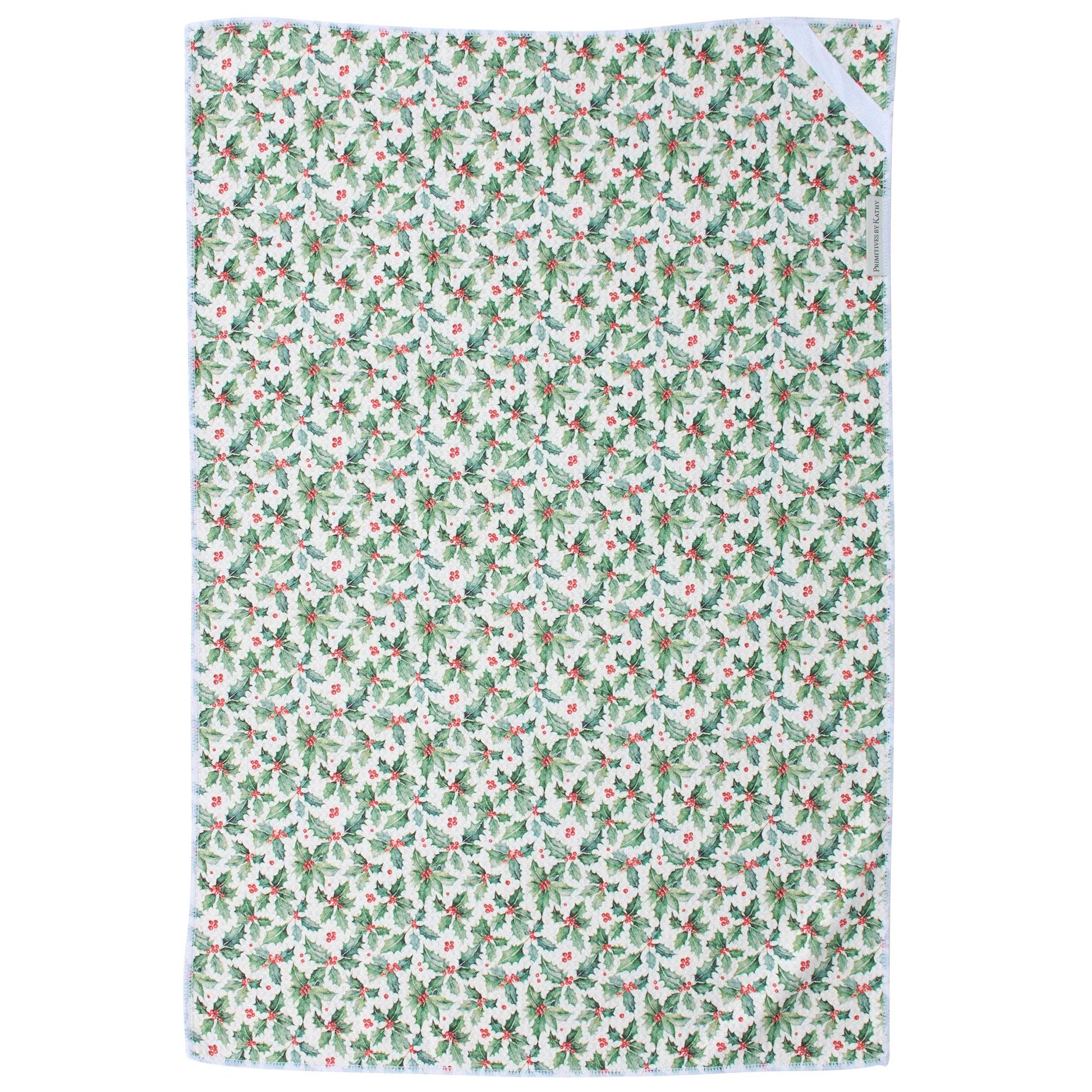 A rectangular kitchen towel with a repeating holly and berry pattern in green, and red on a white background, featuring a white border and a white ribbon tie at the top right.