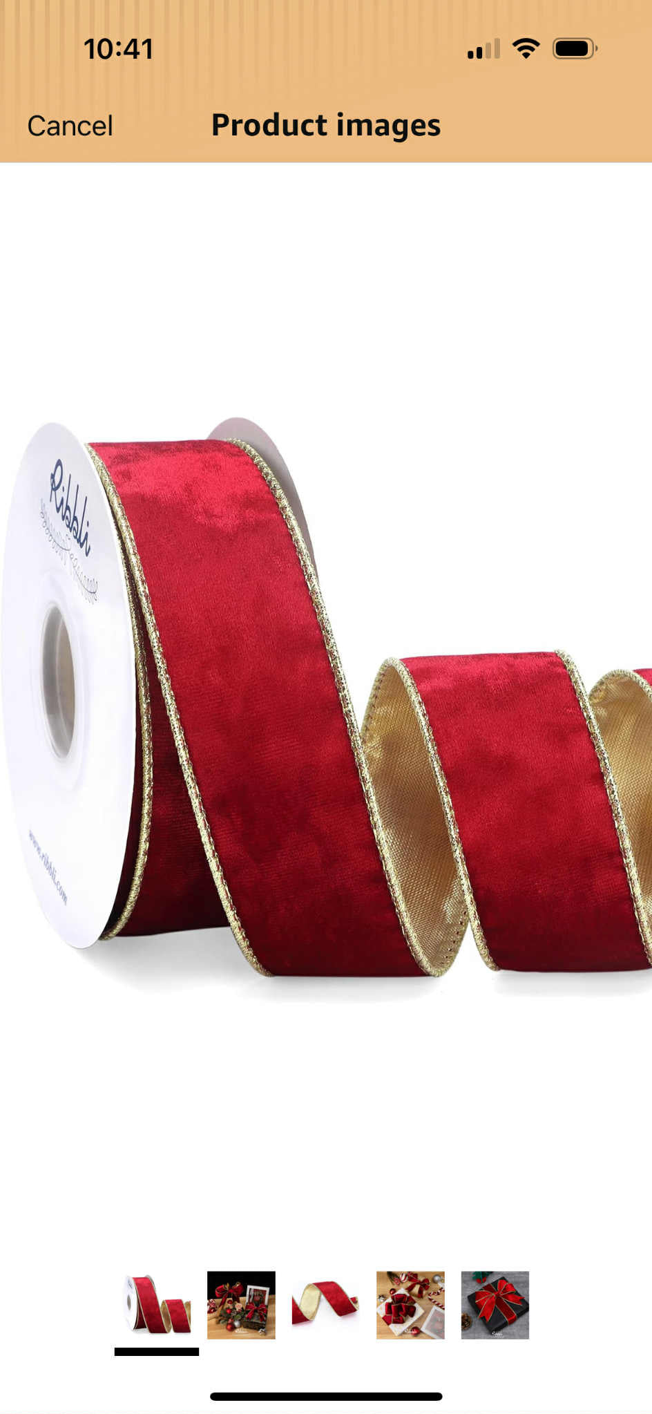 Red ribbon with gold trim on white roll on white background
