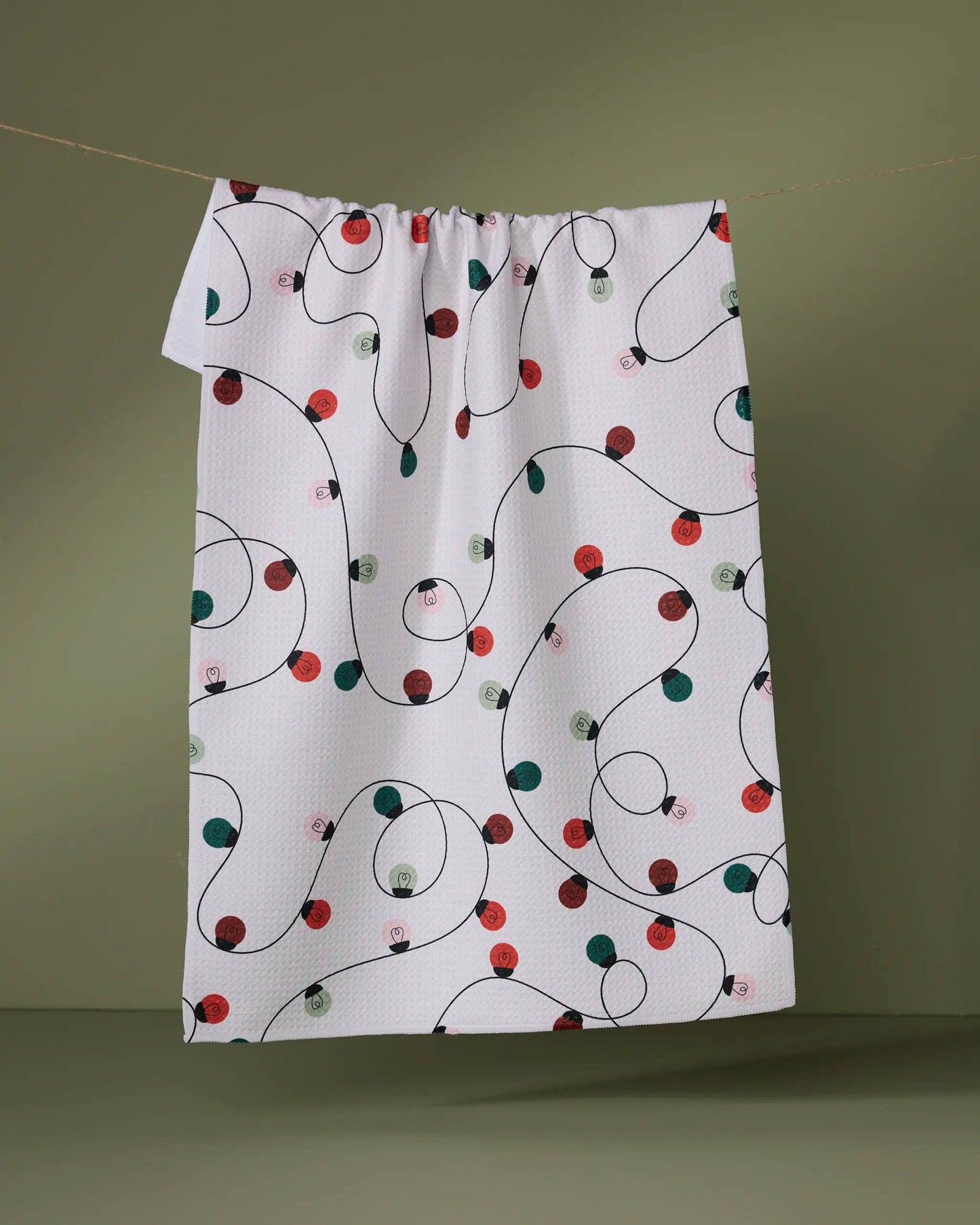 Geometry Tea Towel Fabric with Christmas light pattern on a green background