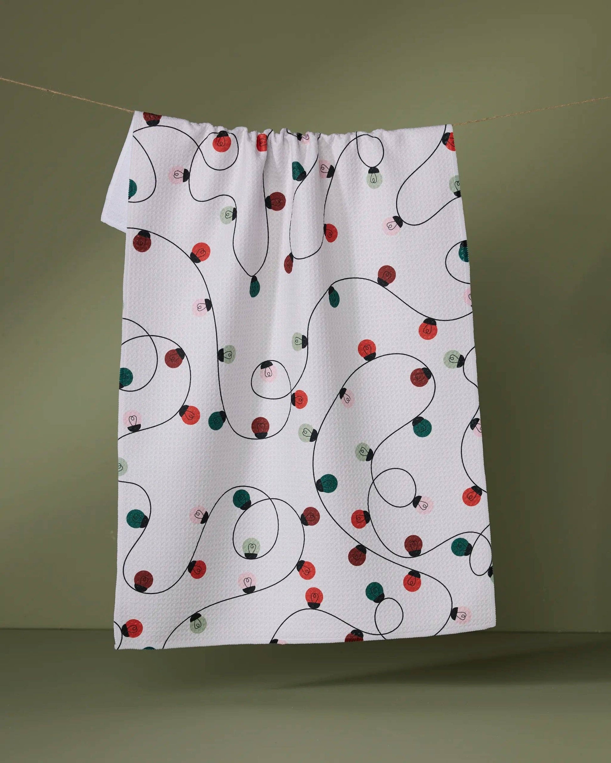Geometry Tea Towel Fabric with Christmas light pattern on a green background
