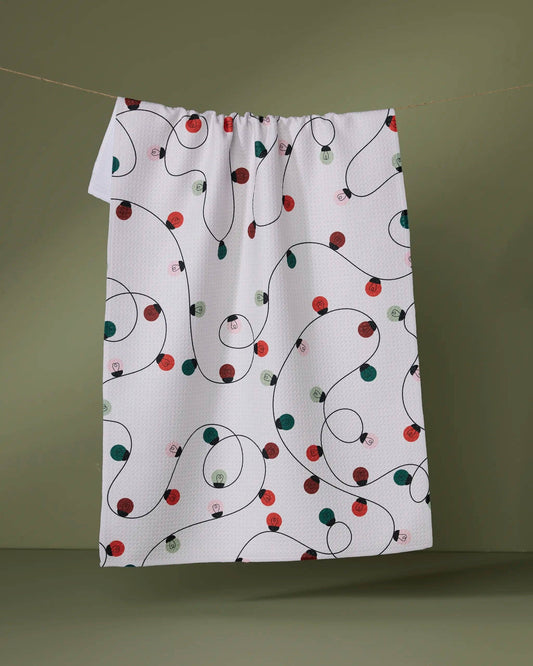 Geometry Tea Towel Fabric with Christmas light pattern on a green background