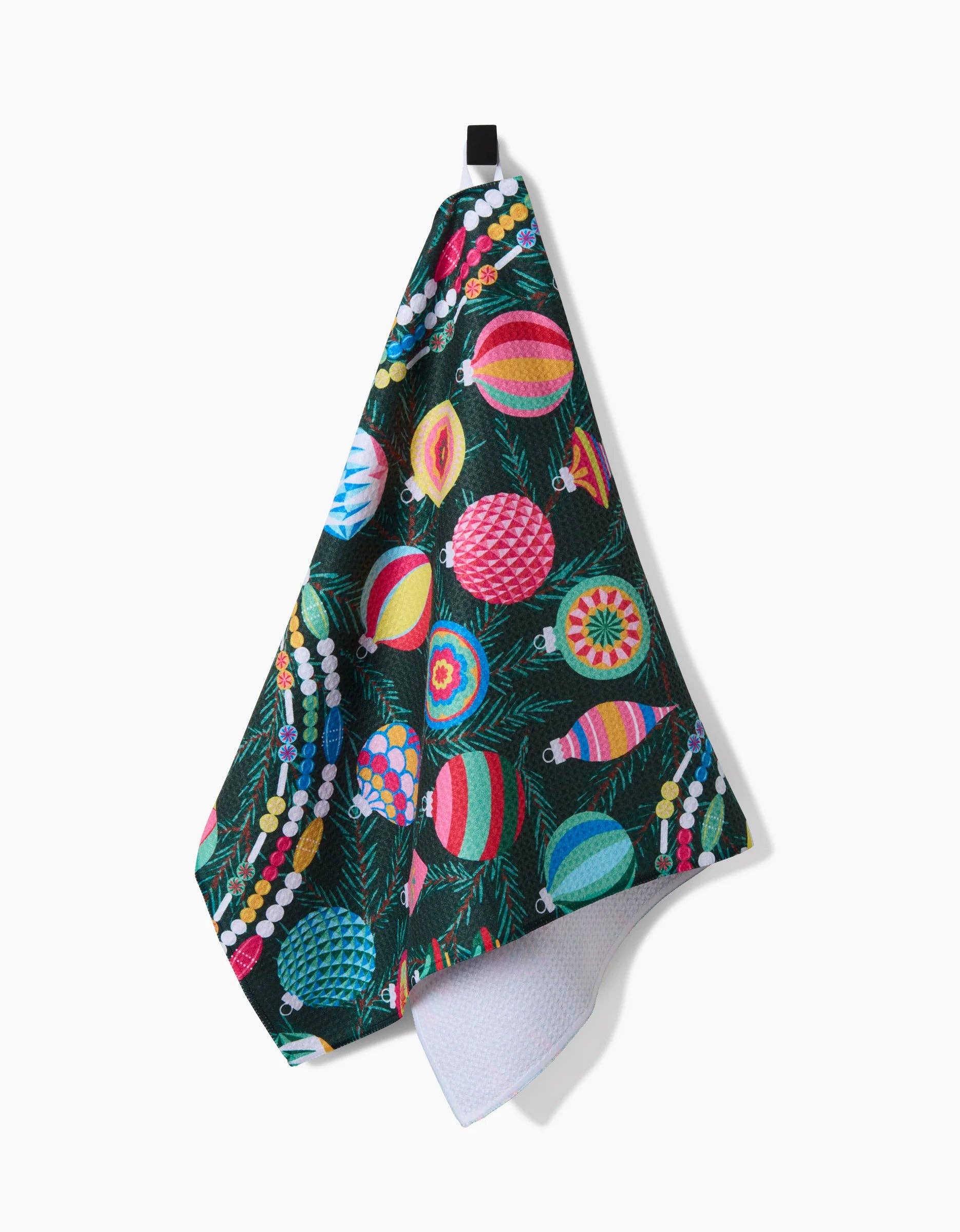 Geometry Tea Towel Colorful towel with festive design hanging on a white background