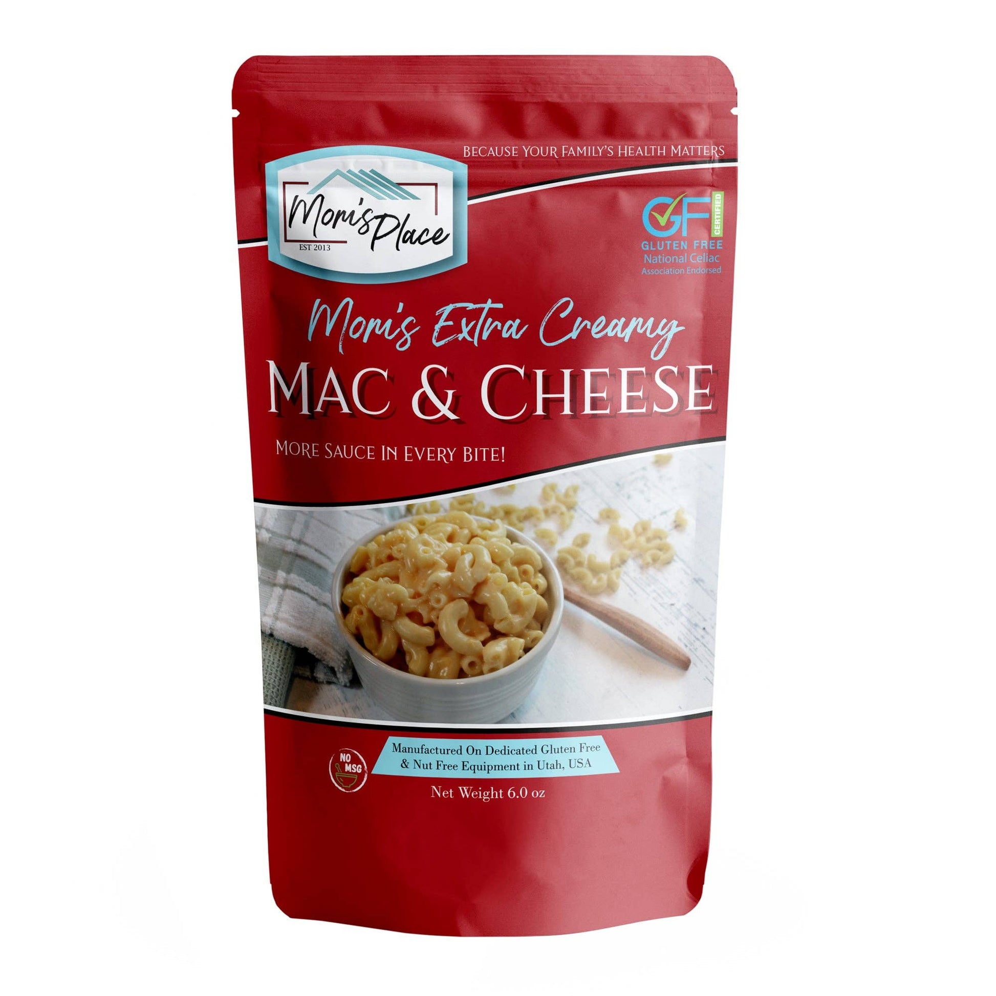 Red package of Mom's Place Extra Creamy Mac & Cheese on a white background