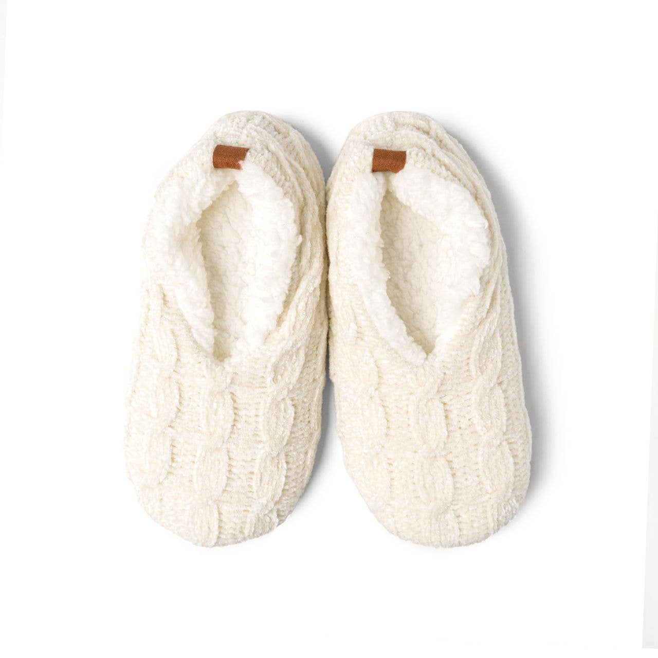 Pair of white cable knit slippers on a light gray background