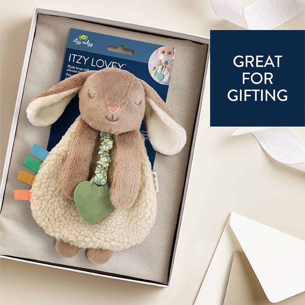 Stuffed bunny toy with colorful teethers in a gift box, labeled 'Itzy Lovey'.