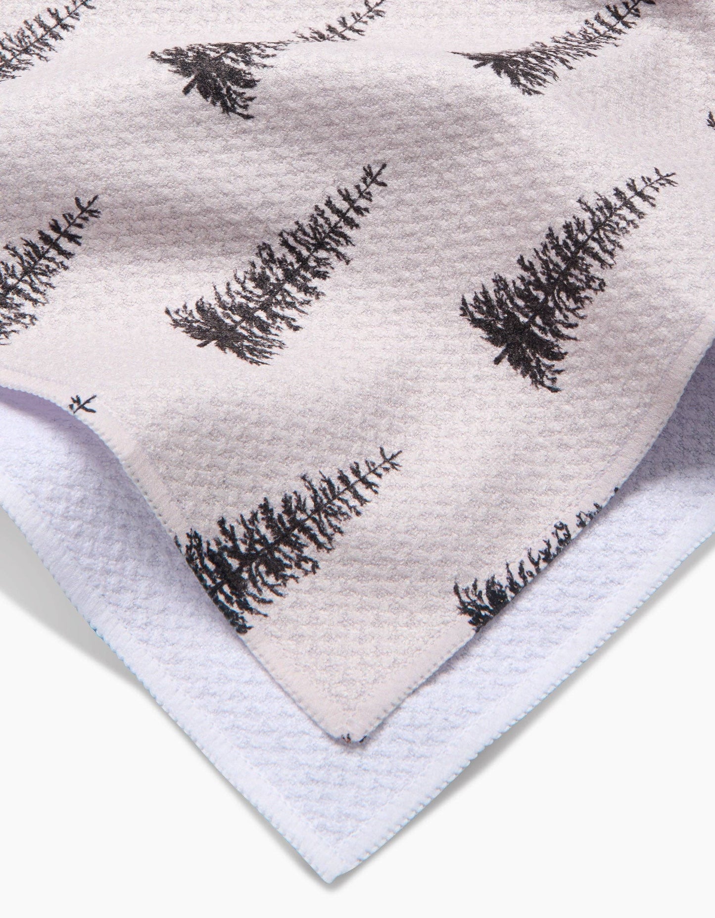 Geometry Tea Towel Alpine Forest Textile with black tree pattern on a light background