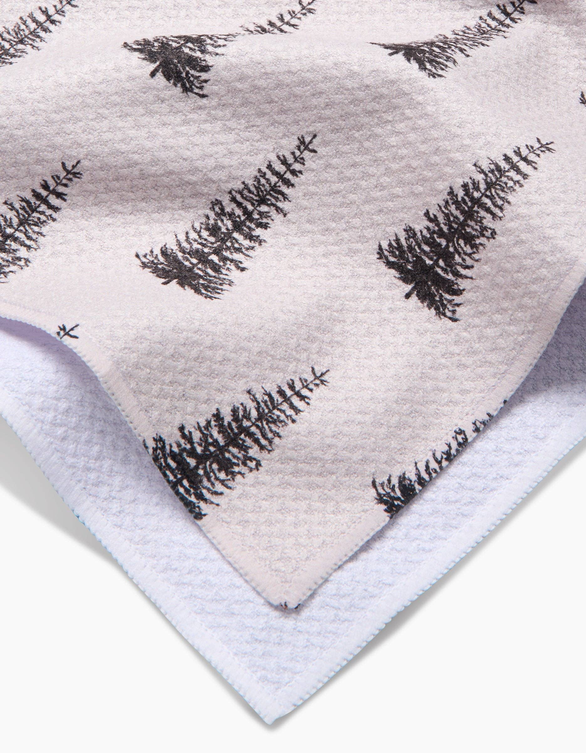 Geometry Tea Towel Alpine Forest Textile with black tree pattern on a light background