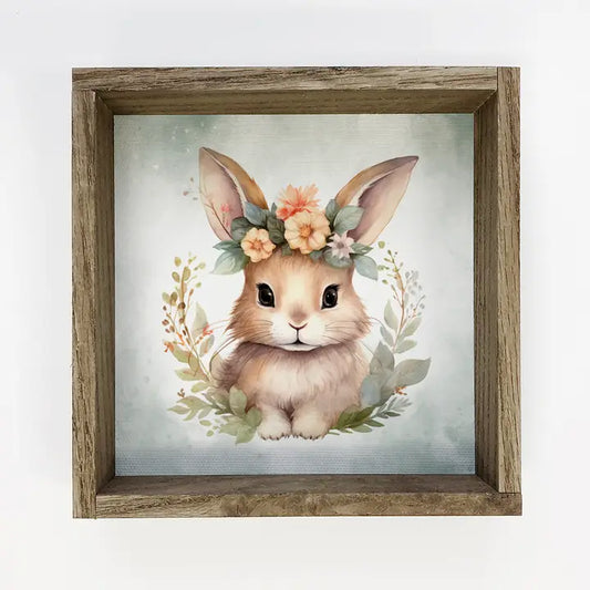 Framed artwork of a bunny with floral crown on a light background