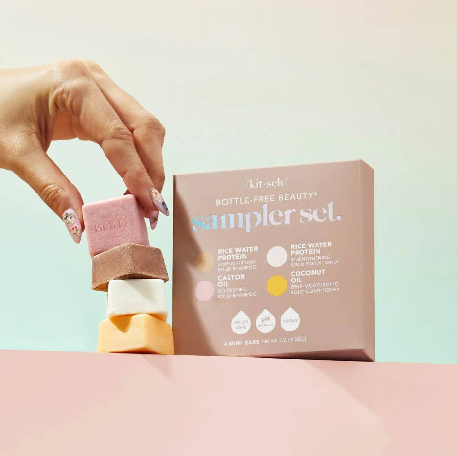 Hand holding a pink bar of soap next to a 'Bottle-Free Beauty' kit on a light background