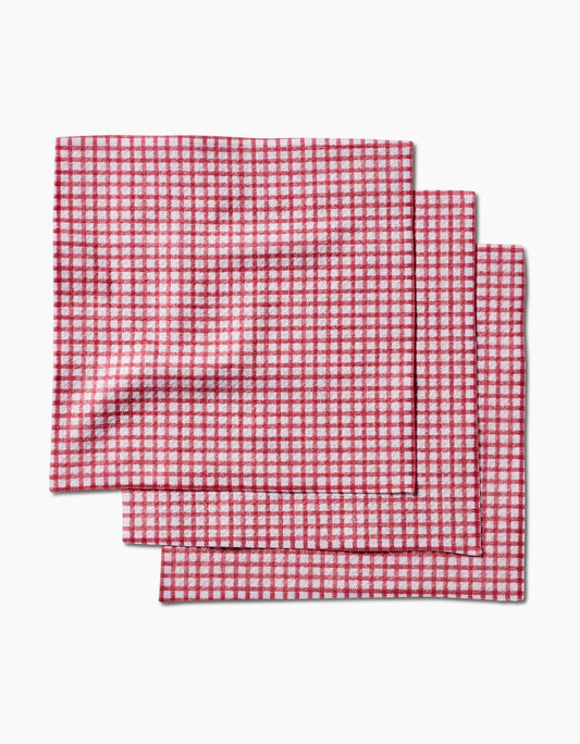Three red and white checkered placemats on a white background