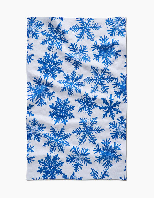 Geometry Kitchen Tea Towel with blue snowflake pattern on a white background