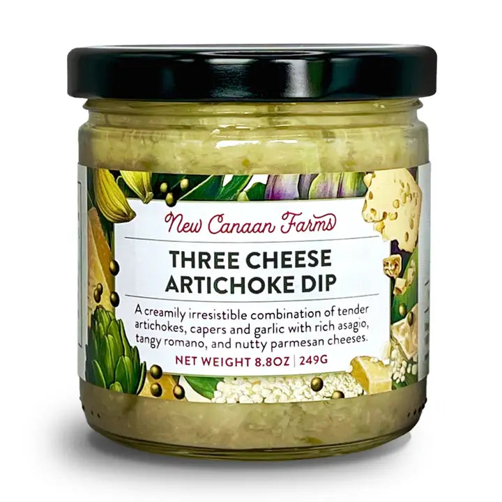 A jar of New Canaan Farms Three Cheese Artichoke Dip with a black lid and a colorful label, shown on a white background.