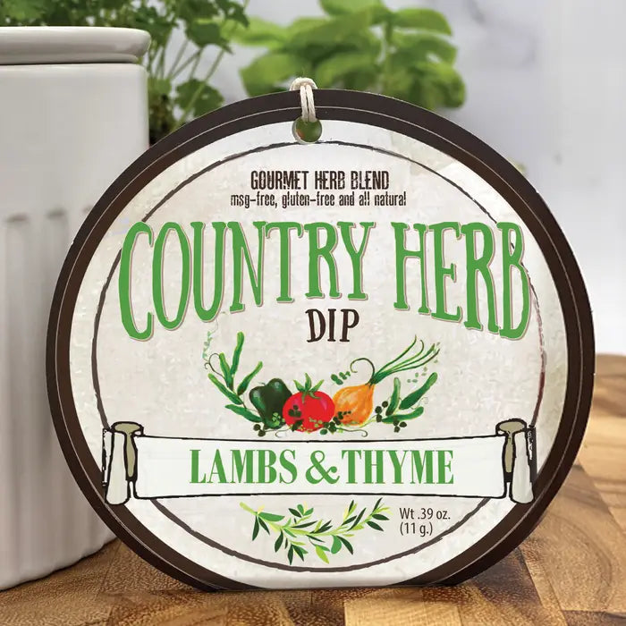 Round label for Country Herb Dip with branding and product details on a wooden surface from Lambs & Thyme
