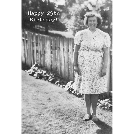 Black and white photo of a woman in a floral dress standing outdoors with 'Happy 29th Birthday!' text.