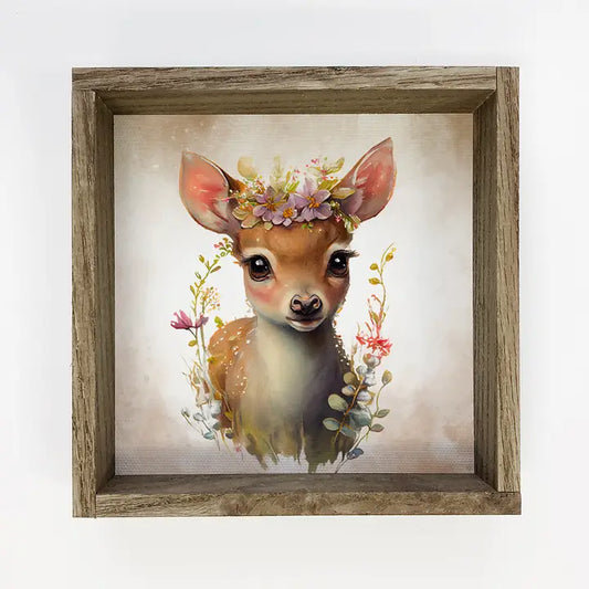 Framed artwork of a deer with flowers on a light background