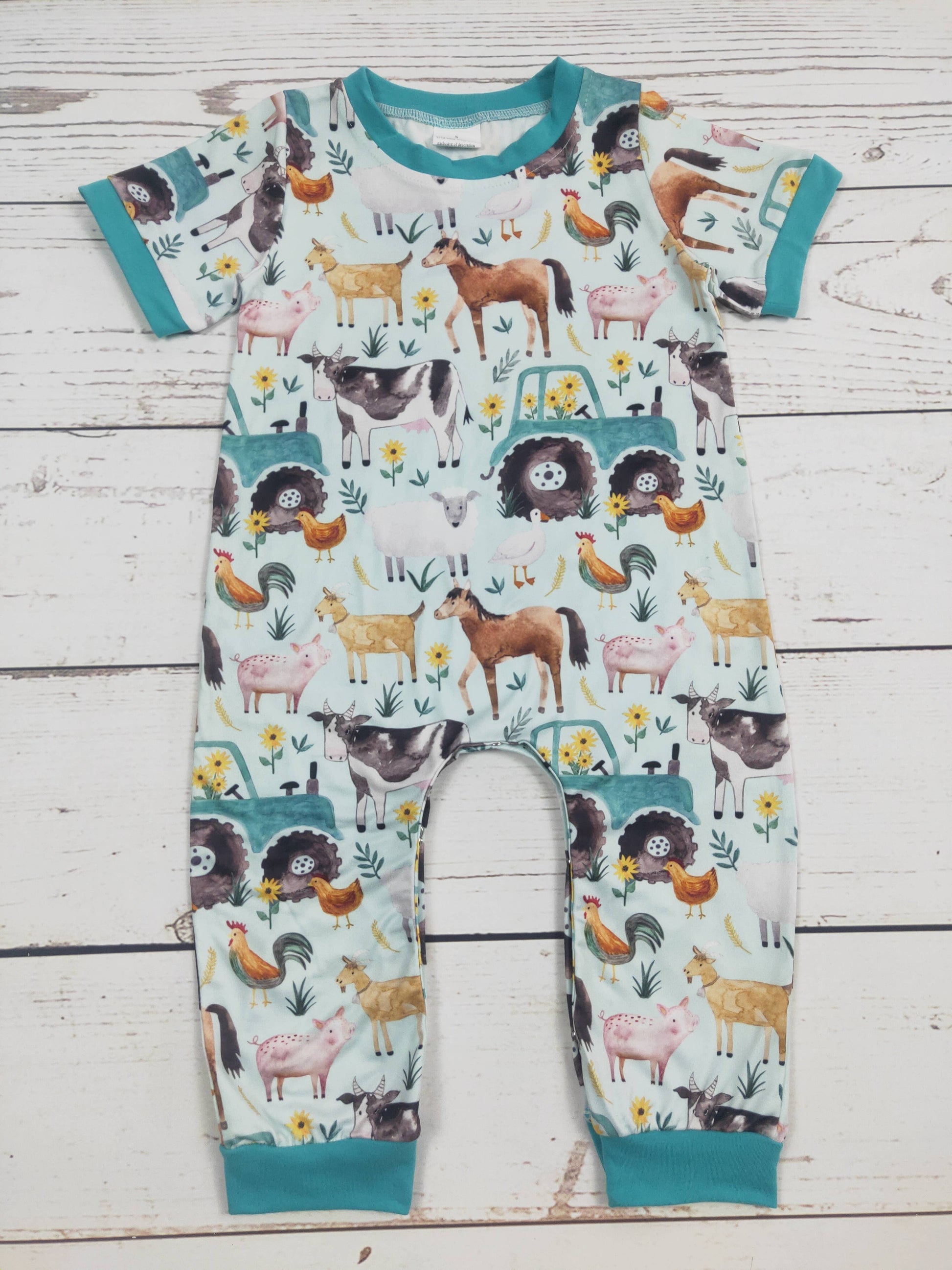 Children's onesie with animal pattern on a wooden surface