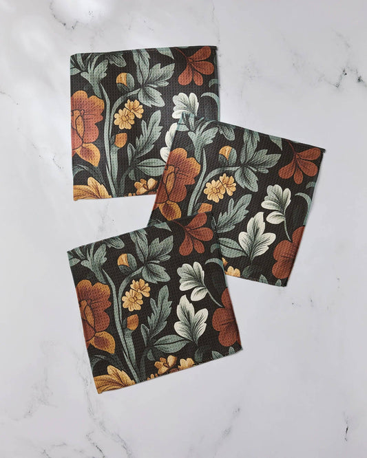 Set of three Geometry dishcloths with floral-patterned  on a white marble surface