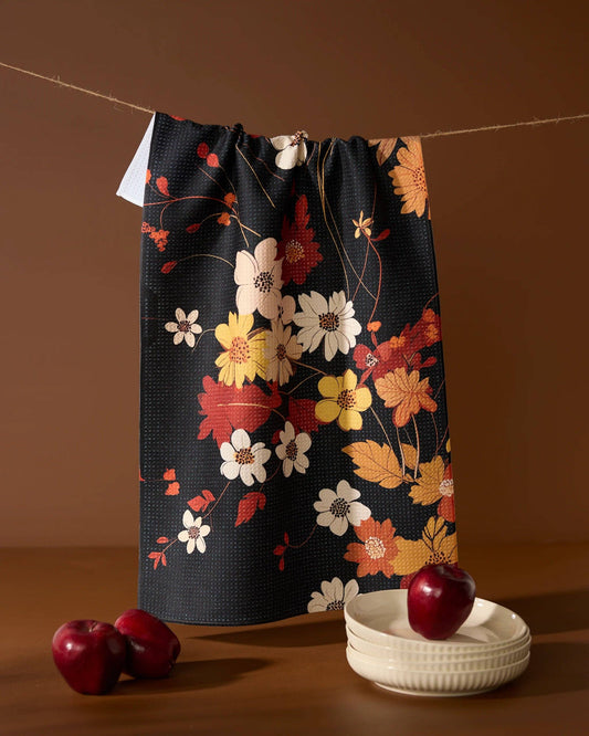Geometry kitchen tea towel with floral-patterned bag on a string with apples and a bowl on a brown background