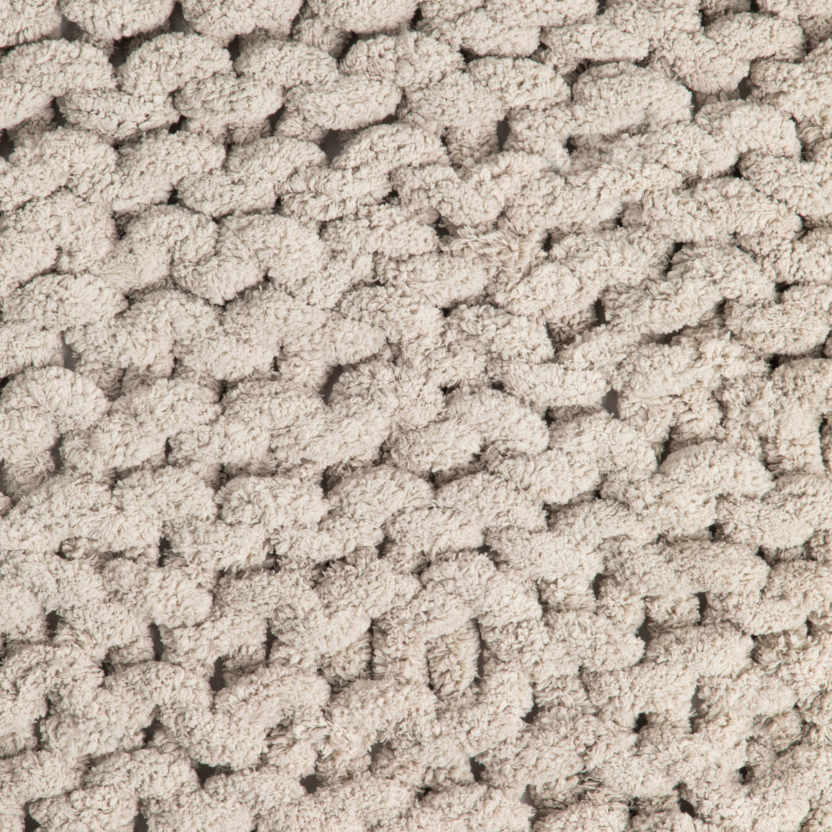 Close-up of textured taupe knit blanket