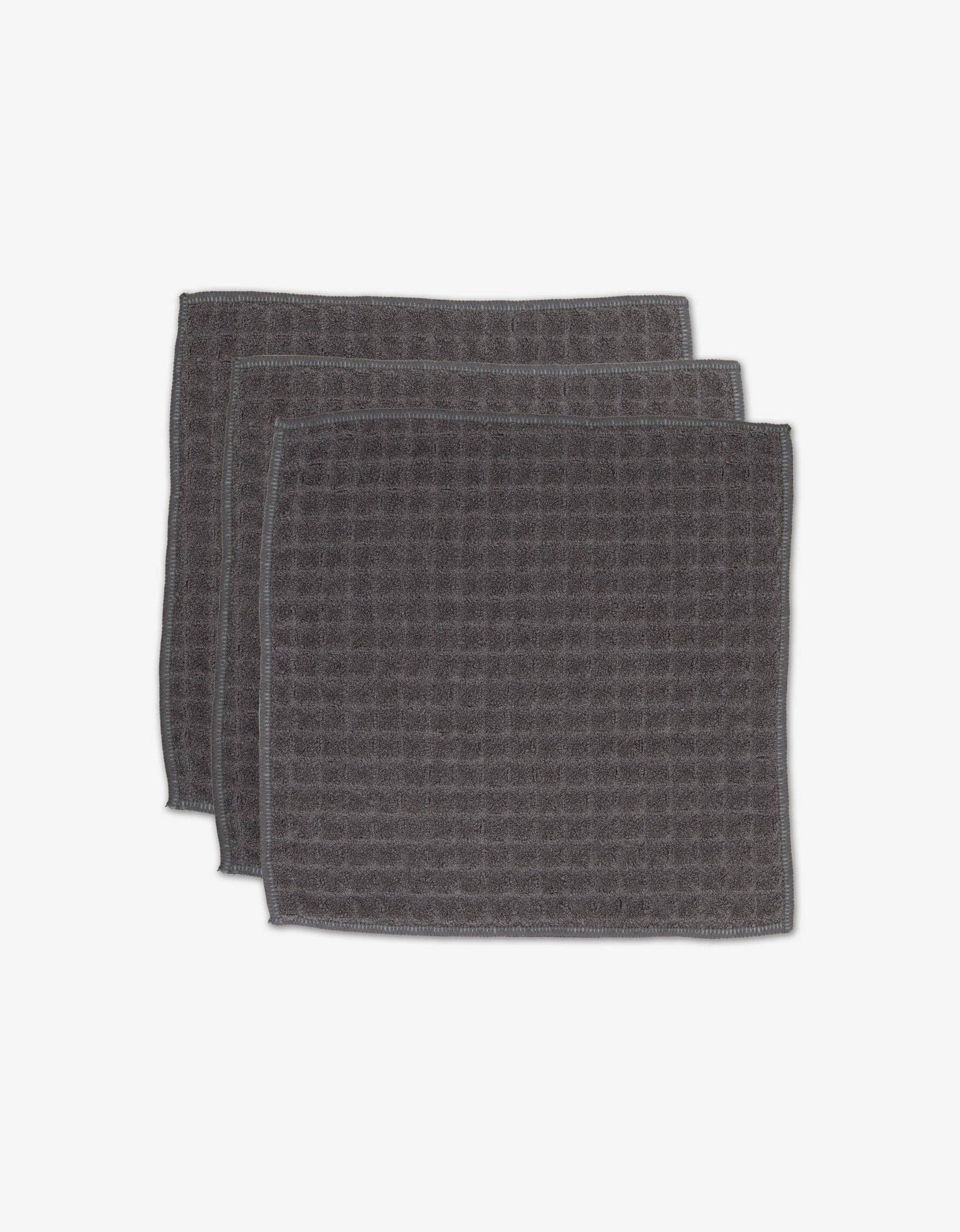 Geometry Waffle Washcloth Set Charcoal  set of 3 dark gray textured towels stacked on a white background