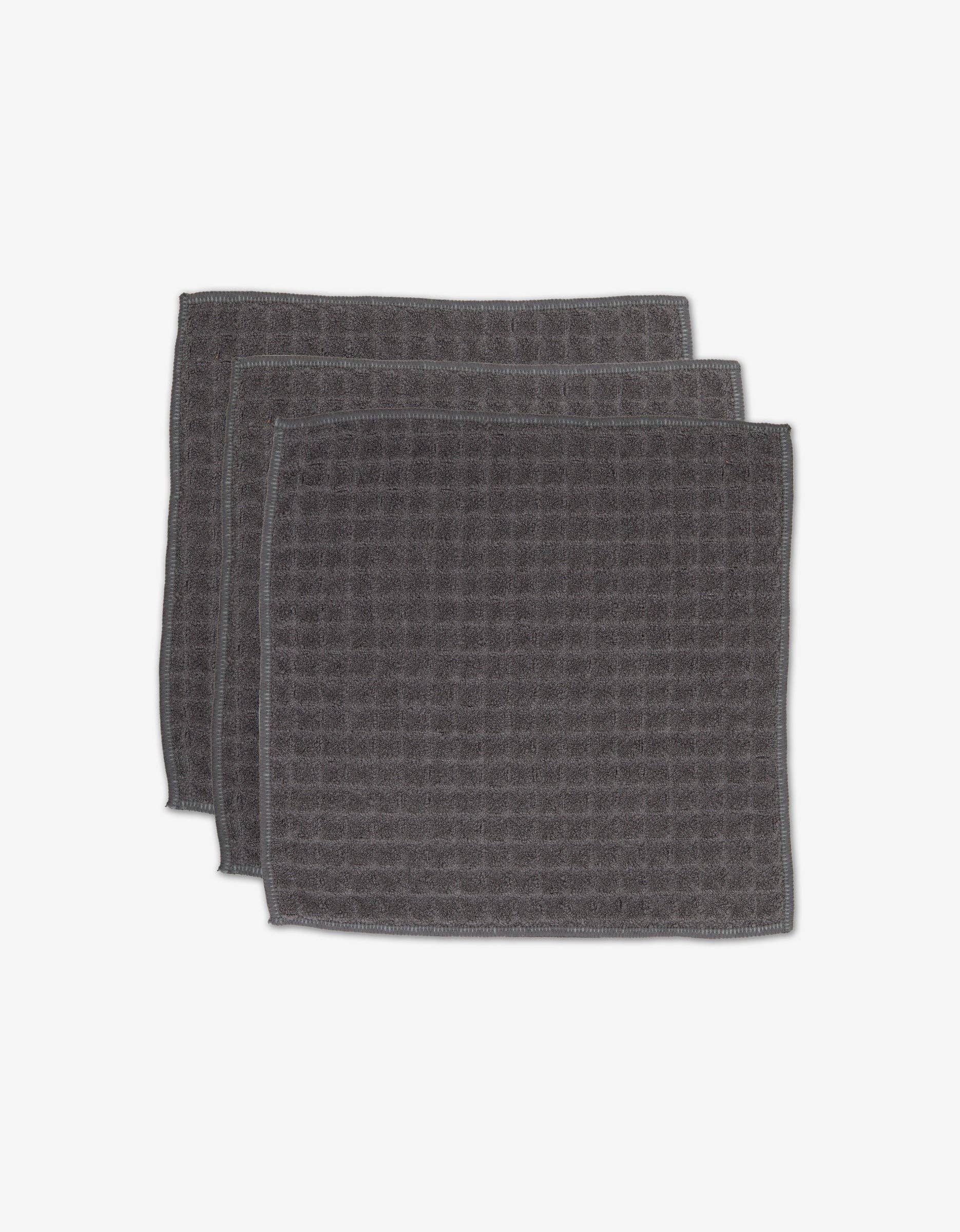 Geometry Waffle Washcloth Set Charcoal  set of 3 dark gray textured towels stacked on a white background