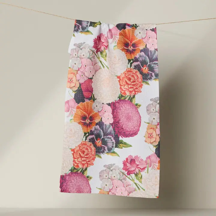 Floral patterned Geometry bar towel hanging on a line against a neutral background