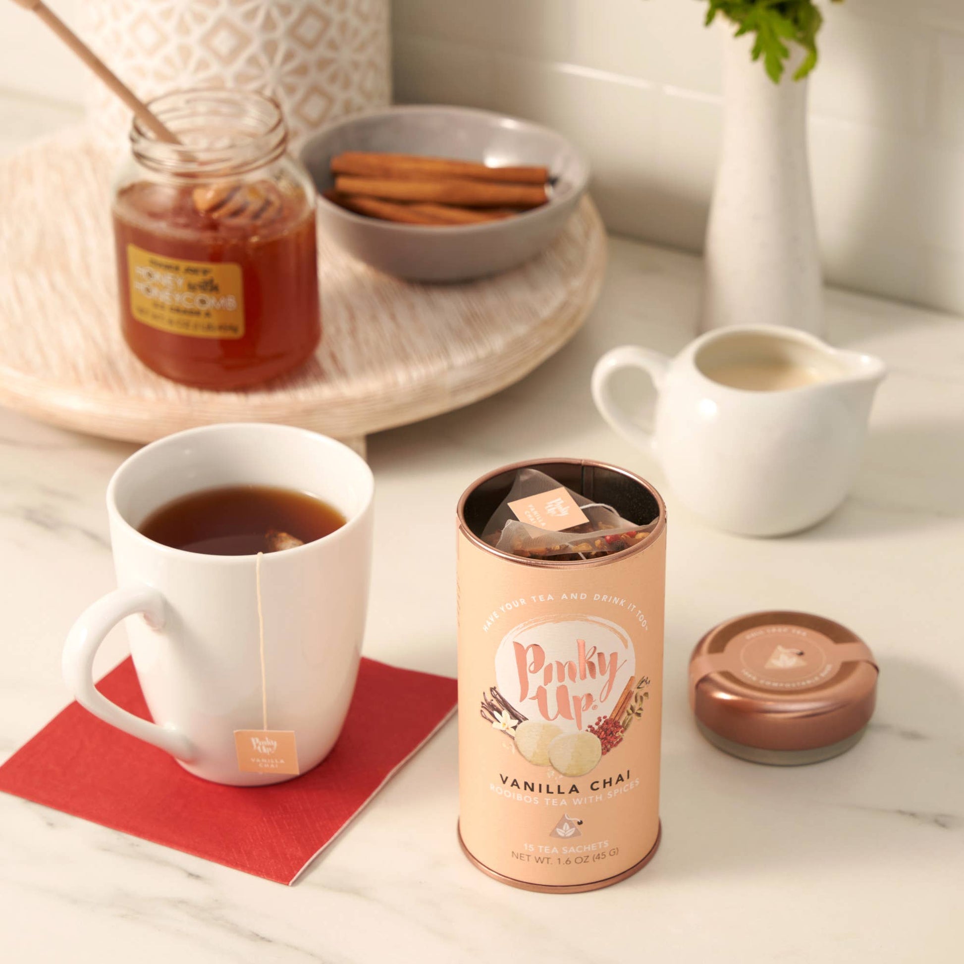 Vanilla chai tea canister with a cup of tea on a table