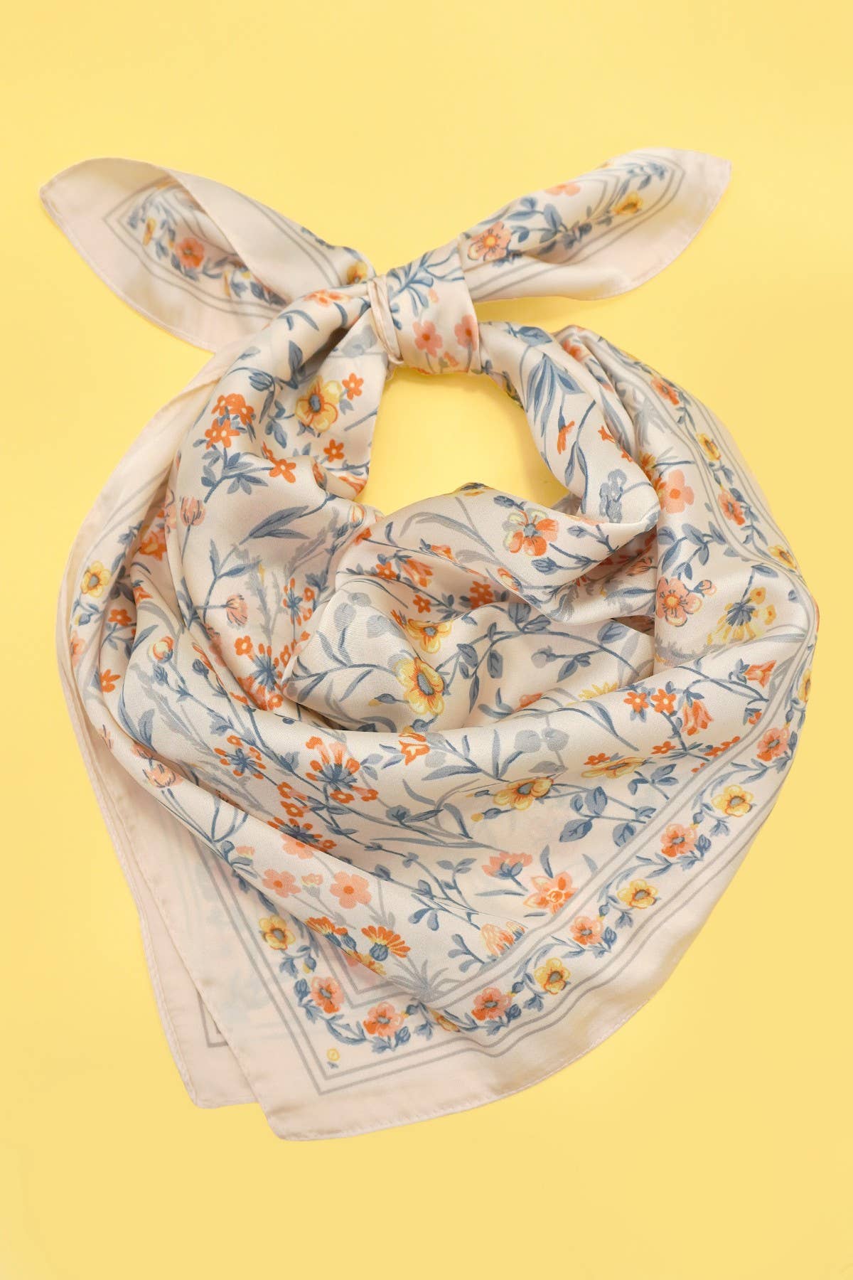 Floral patterned scarf on a yellow background