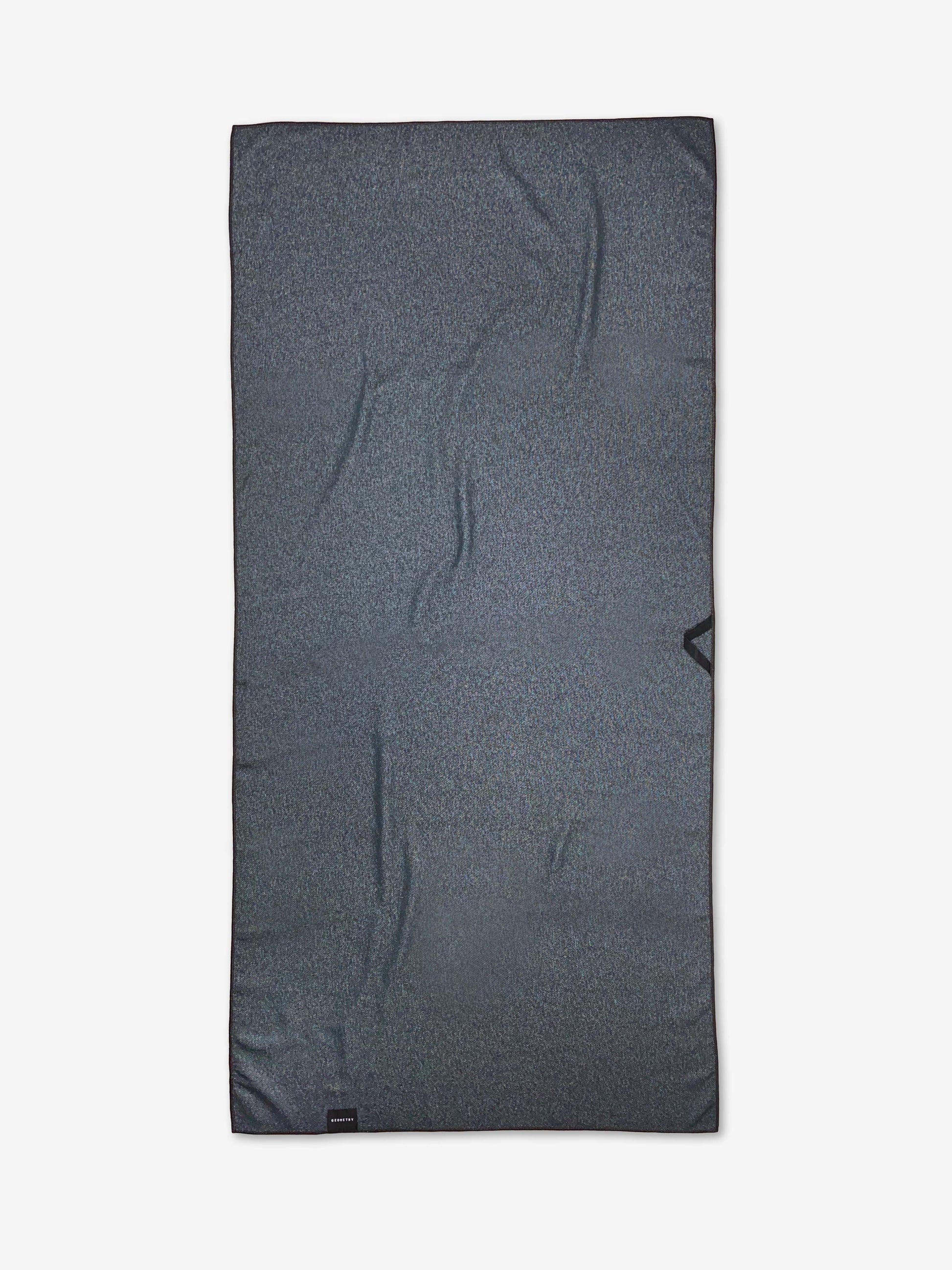 Gray rectangular back of a beach towel with a brand logo on a white background