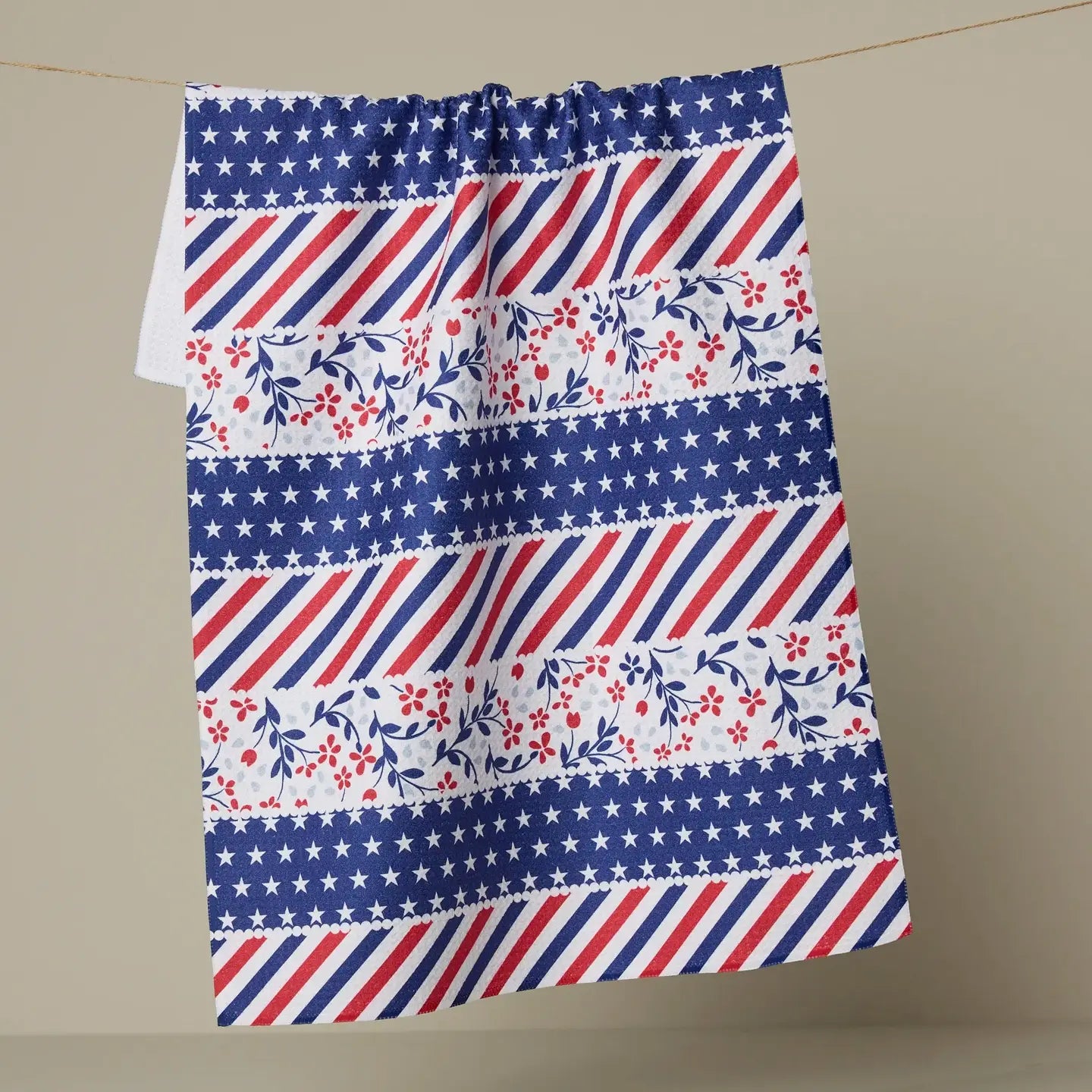 Decorative Geometry tea towel with red, white, and blue patterns on a beige background