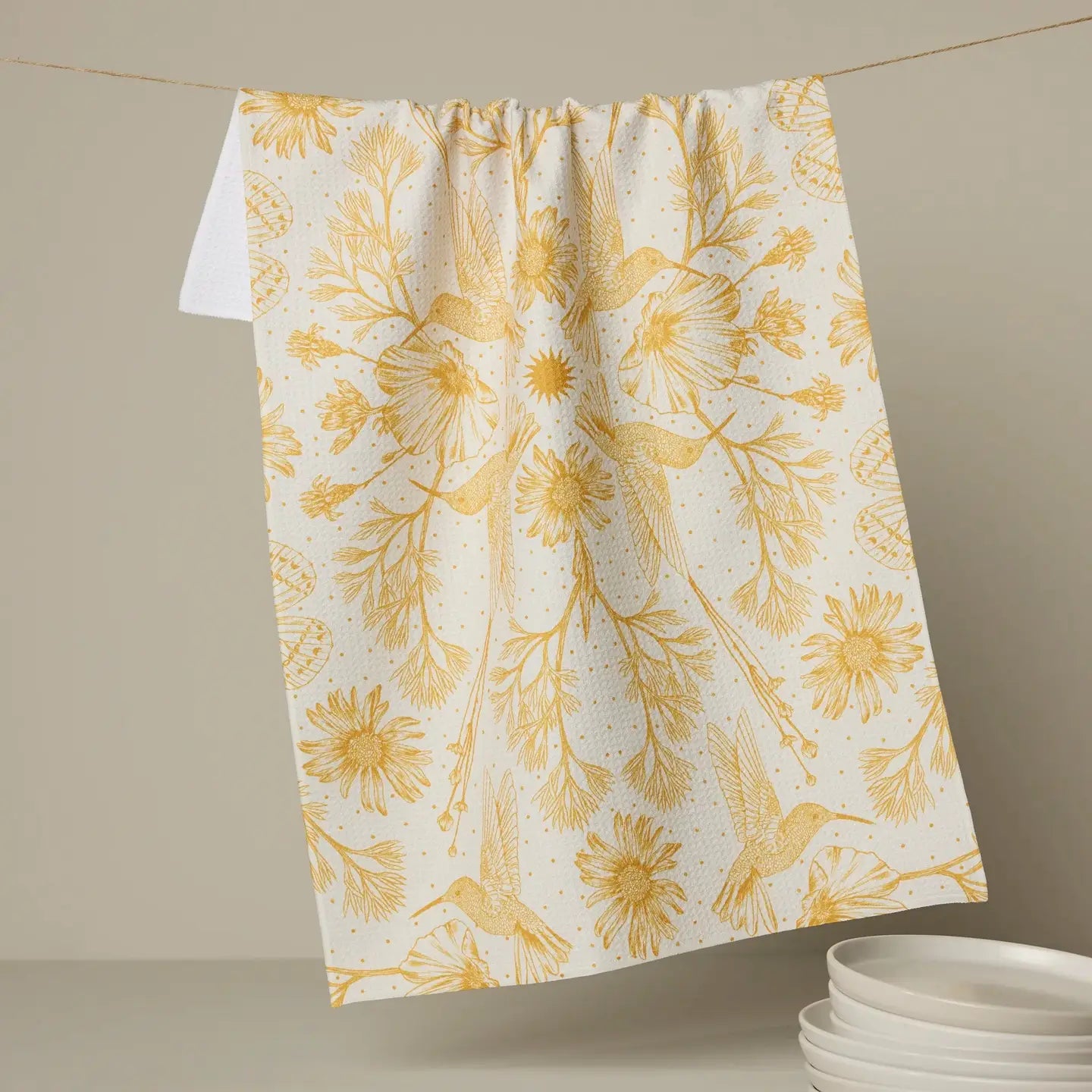 Floral patterned Geometry tea towel hanging on a line with a neutral background