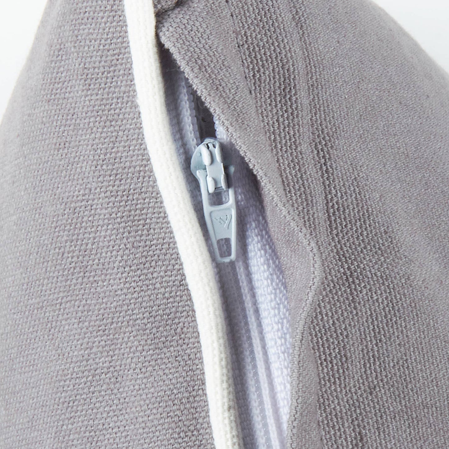 Close-up of a gray textured fabric with a zipper detail