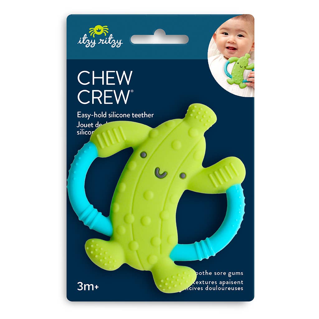 Green and blue silicone pickle teether with 'ity ritzy' packaging on a white background