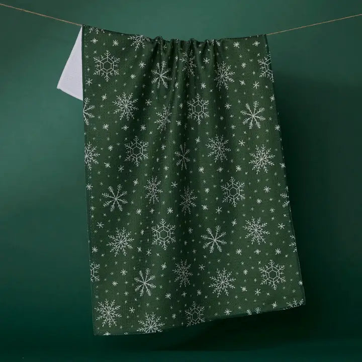 Snowflake patterned Geometry Tea Towel on a green background
