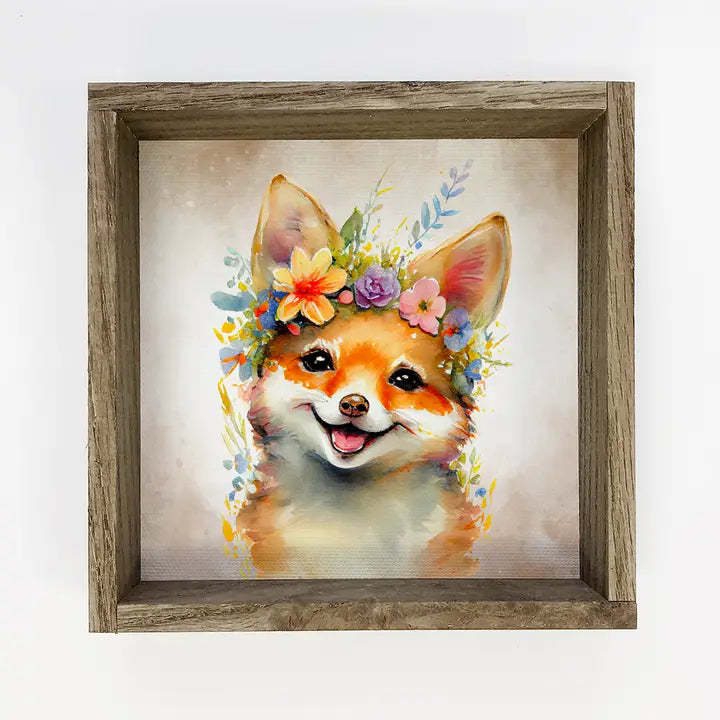 Framed artwork of a fox with a floral headband on a light background