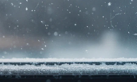 Window pane with snow falling  in a snowstorm
