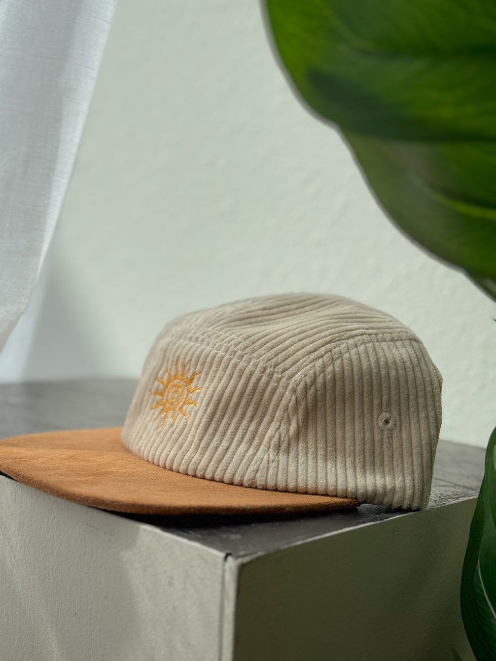 Beige Corduroy Hat with sun embroidery on table with white background